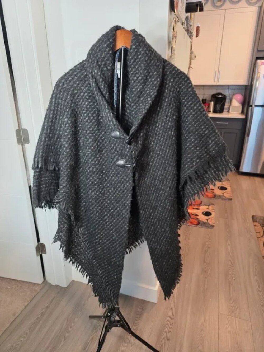 Wool blend poncho cape with fringe trim and toggle closure